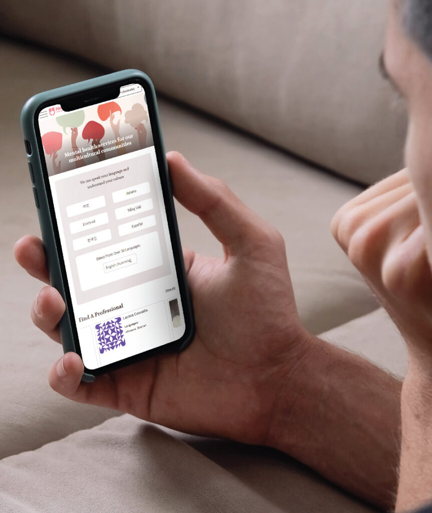 A person holding a phone showing the HeartChat website
